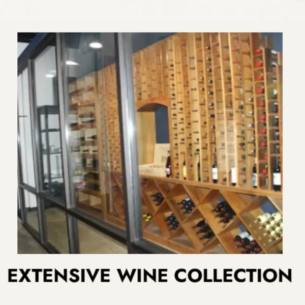 A large, glass-enclosed wine cellar with wooden racks filled with numerous wine bottles.